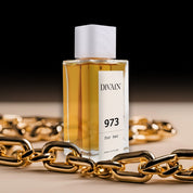 Parfum divain-973 entouré d'une chaîne en or qui donne une impression de luxe.